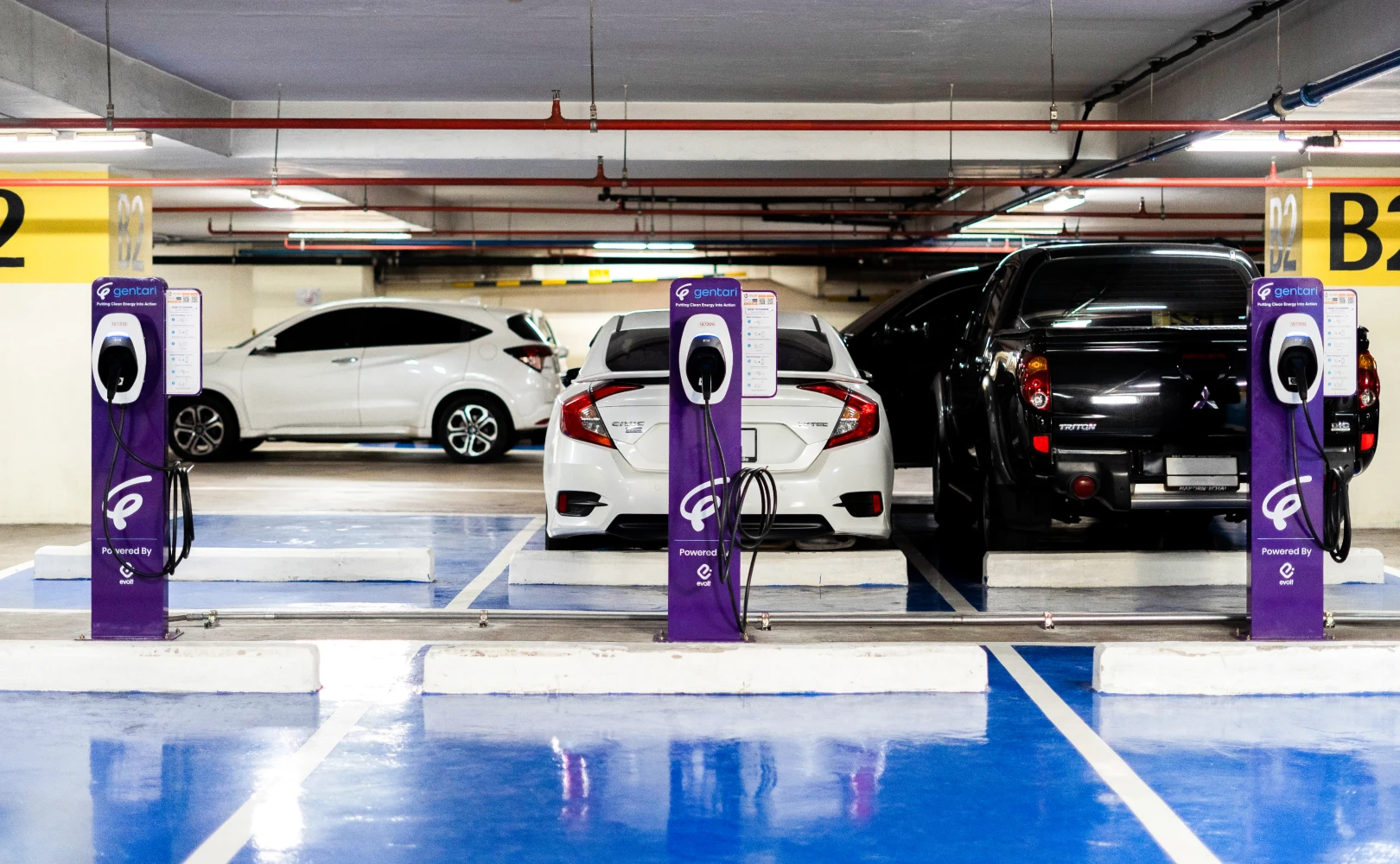 Car charging at EV station: Gentari drives Thailand's green mobility with extensive EV networks and public education, aligning with national environmental goals